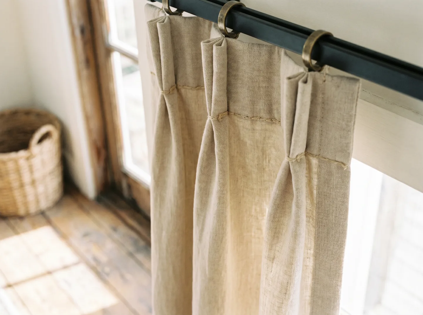 A triple pinch pleat heading in oat linen, three crisp folds gathered at the base